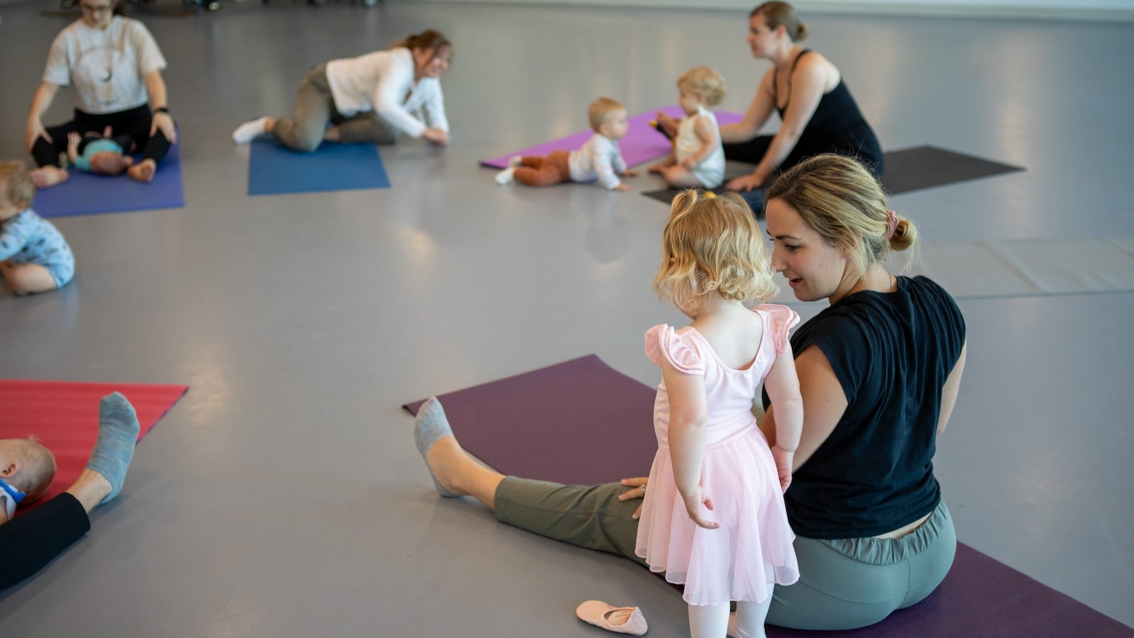 Parents and small children in a dance studio