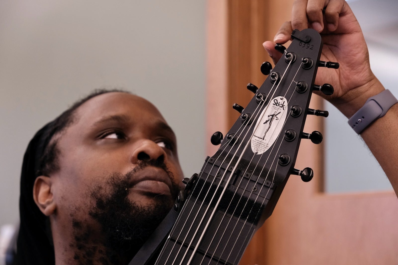 Man tuning a Chapman Stick