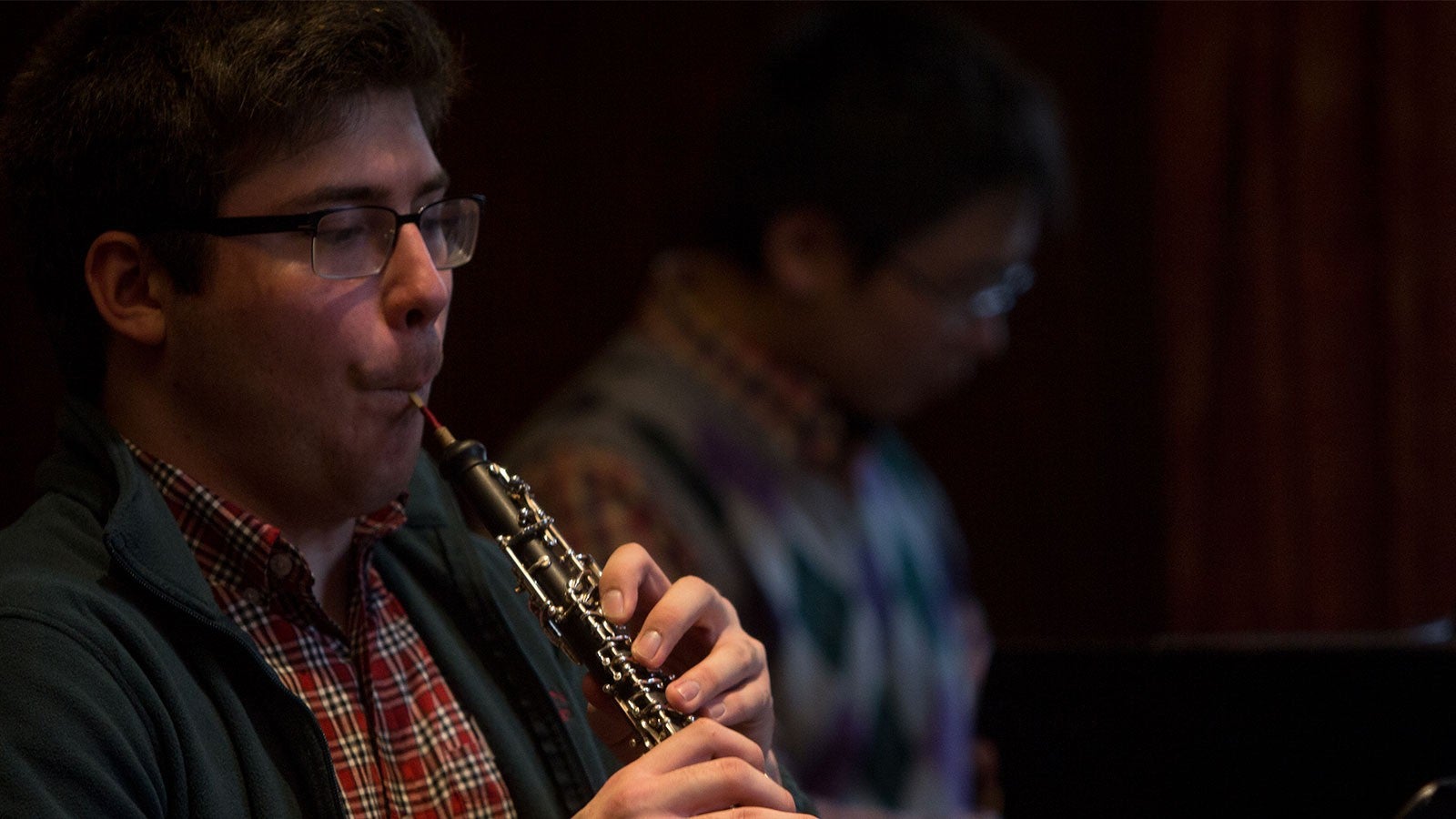 A boy playing the oboe