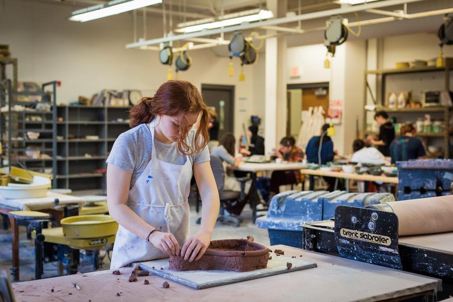 Arts Academy student works on ceramic project in visual arts building