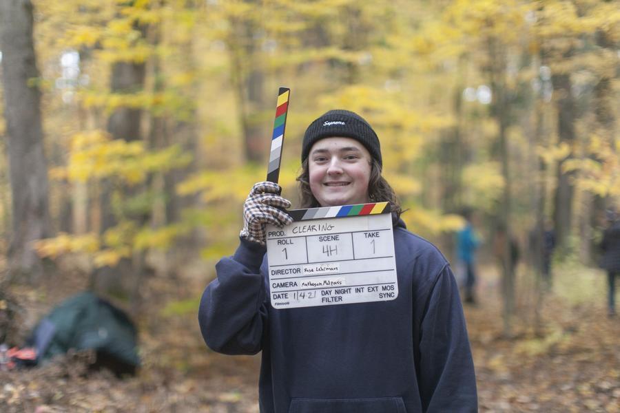 Arts Academy student holds slate at outdoor shoot