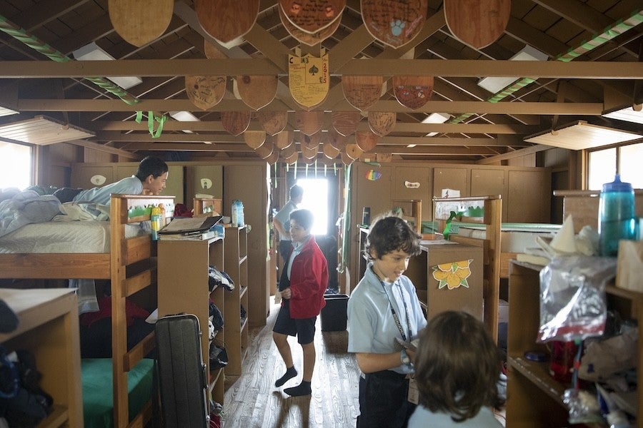 Interior of junior boys' cabin with some of the boys inside.