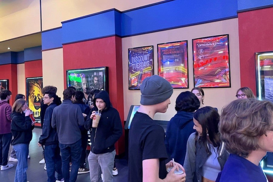 A group of students near movie posters