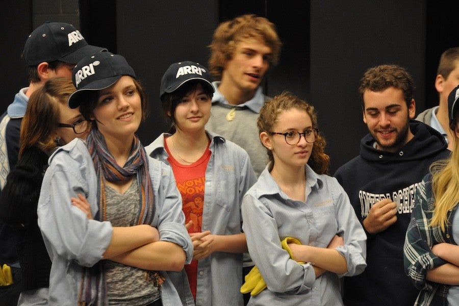 Shireen Hinckley stands in the middle of a group Interlochen film students in light blue shirts and ARRI caps.