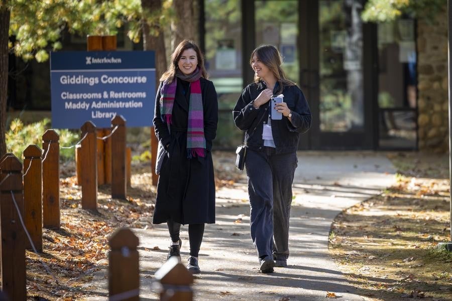 Two alumni enjoy a stroll on Interlochen's campus.