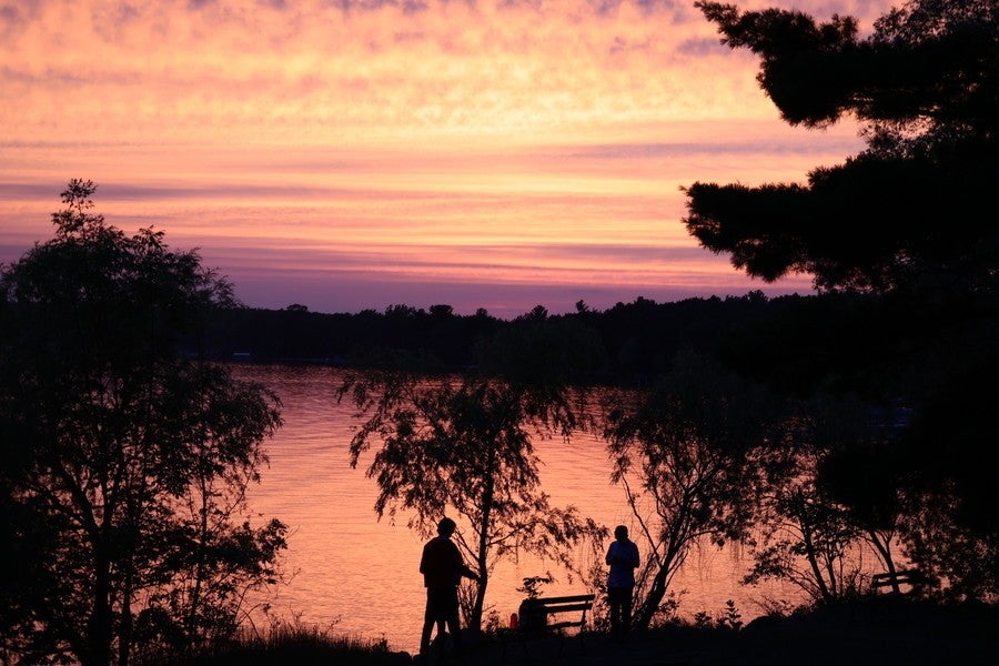 The sun rises over the lake at Interlochen.