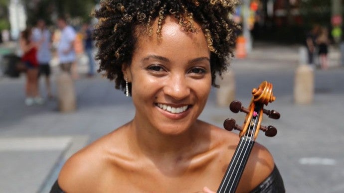 A smiling woman with a violin