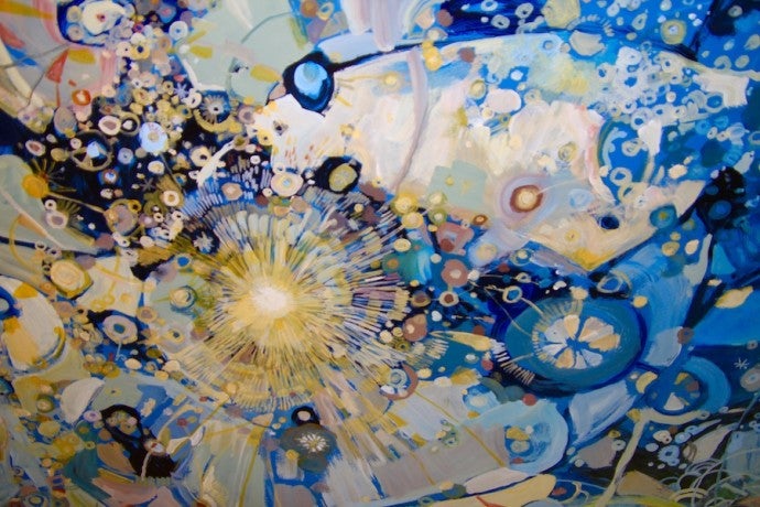 A photograph of a ceiling painted with celestial shapes in blue and gold.