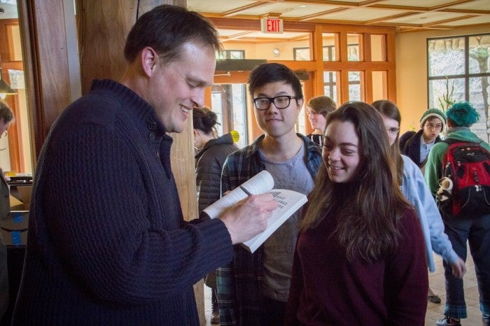 Guest writer Garth Greenwell signing his book for an Interlochen student.