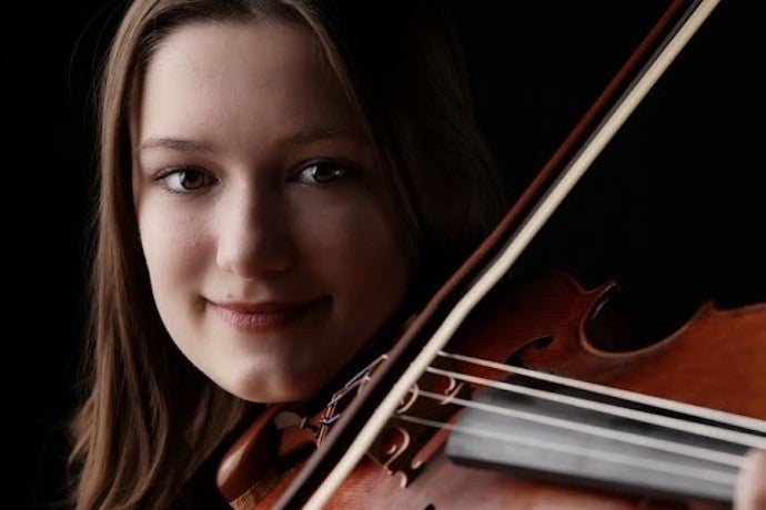 A portrait photo of Lily playing her viola.