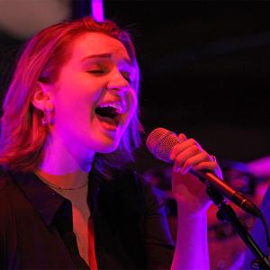 A singer-songwriter student performs at the City Opera House