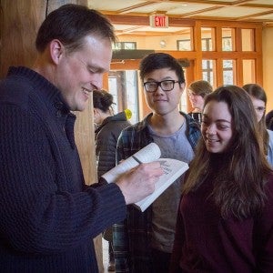 Guest writer Garth Greenwell signing his book for an Interlochen student.