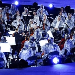 Musicians from the French National Orchestra wore ponchos to keep off the rain during the opening ceremony of the Paris 2024 Olympic Games (Mike Egerton/PA).