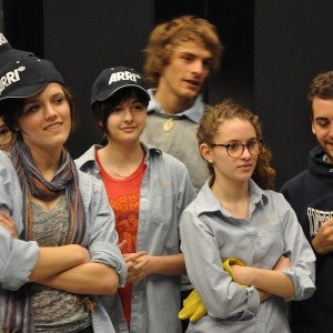 Shireen Hinckley stands in the middle of a group Interlochen film students in light blue shirts and ARRI caps.