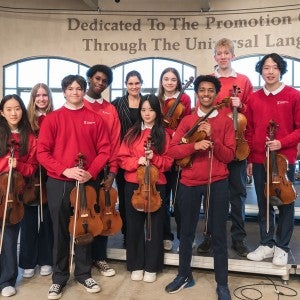 Interlochen Arts Camp students smile with guest conductor