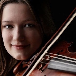 A portrait photo of Lily playing her viola.