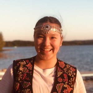 Headshot of Assyl Rassulkyzy in front of a lake