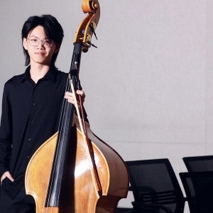 A student poses with a double bass.